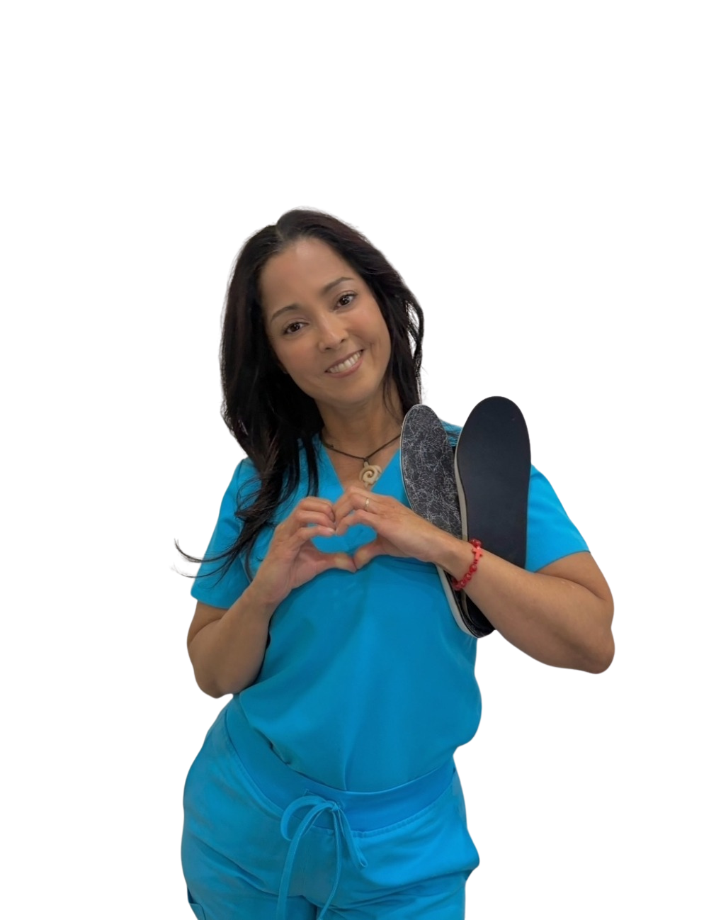 Sandra Costlow, certified pedorthist at For Your Feet FL, forming a heart with her hands while holding a custom orthotic